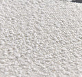 Ninon   Pouf repose-pieds tapiss  en bouclette blanche
